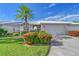 Villa with mature landscaping, a driveway, and a two-car garage at 5395 Christie Ann Pl # 9, Sarasota, FL 34233