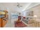 Comfortable living room with tile flooring, ceiling fan, and seamless access to the outdoor patio at 5395 Christie Ann Pl # 9, Sarasota, FL 34233