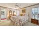 Main bedroom features a ceiling fan, artwork, and ensuite bathroom access at 5395 Christie Ann Pl # 9, Sarasota, FL 34233