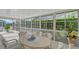 Enclosed patio featuring a round table with six chairs and screens for enjoying outdoor living at 5395 Christie Ann Pl # 9, Sarasota, FL 34233
