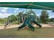 Community playground featuring multiple slides, climbing structures, and sunshade for outdoor fun at 5395 Christie Ann Pl # 9, Sarasota, FL 34233