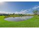 Scenic view of the pond, showcasing the serene backyard and well-maintained landscaping at 5395 Christie Ann Pl # 9, Sarasota, FL 34233