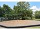 Community swings set for outdoor fun with mature trees and picnic area in the background at 5395 Christie Ann Pl # 9, Sarasota, FL 34233