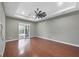Spacious bedroom with hardwood floors, ceiling fan, and sliding doors to the pool at 575 Fore Dr, Bradenton, FL 34208