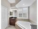 Bathroom with soaking tub, vanity, and window at 575 Fore Dr, Bradenton, FL 34208