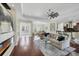 Open living area with hardwood floors and views into the kitchen and dining room at 575 Fore Dr, Bradenton, FL 34208