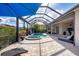 Enclosed pool and spa with patio furniture at 575 Fore Dr, Bradenton, FL 34208