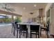 Outdoor kitchen with island, grill, and pool view at 575 Fore Dr, Bradenton, FL 34208