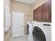 Laundry room with washer, dryer, and cabinets at 575 Fore Dr, Bradenton, FL 34208