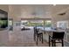 Outdoor kitchen with island, grill, and pool view at 575 Fore Dr, Bradenton, FL 34208