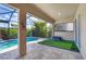 Covered patio area with pool and artificial turf at 575 Fore Dr, Bradenton, FL 34208