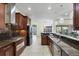 Spacious kitchen featuring granite countertops, stainless steel appliances, and dark wood cabinetry at 575 Fore Dr, Bradenton, FL 34208