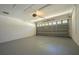 Bright garage featuring a new garage door and fresh epoxy floor at 6227 Blue Runner Ct, Lakewood Ranch, FL 34202