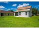 View of house back, showcasing screened porch and yard at 6227 Blue Runner Ct, Lakewood Ranch, FL 34202