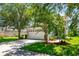 Home's exterior with a two-car garage, landscaping, and a spacious front yard at 6227 Blue Runner Ct, Lakewood Ranch, FL 34202