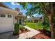 Home's exterior view with a walkway, landscaping, and a two-car garage at 6227 Blue Runner Ct, Lakewood Ranch, FL 34202