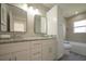 Bathroom with double vanity, granite countertop and large mirror at 6227 Blue Runner Ct, Lakewood Ranch, FL 34202