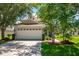 Two-story home with attached garage and landscaped yard at 6227 Blue Runner Ct, Lakewood Ranch, FL 34202