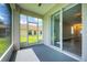 Spacious screened porch with access to backyard and view of the lake at 6227 Blue Runner Ct, Lakewood Ranch, FL 34202