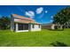Landscaped backyard with screened porch and view of neighboring homes at 6227 Blue Runner Ct, Lakewood Ranch, FL 34202