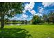 Peaceful lake view from backyard with lush green grass at 6227 Blue Runner Ct, Lakewood Ranch, FL 34202