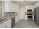 Modern kitchen with white cabinets, granite countertops, and stainless steel appliances at 6227 Blue Runner Ct, Lakewood Ranch, FL 34202