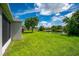 View of backyard, showcasing screened porch and lake at 6227 Blue Runner Ct, Lakewood Ranch, FL 34202