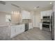 Modern kitchen with white cabinets, granite countertops, and stainless steel appliances at 6227 Blue Runner Ct, Lakewood Ranch, FL 34202