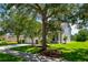 House exterior showcasing a well-maintained lawn, mature trees, and a paved driveway at 6227 Blue Runner Ct, Lakewood Ranch, FL 34202