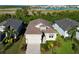 Single-story home with a tile roof, driveway, and view of neighboring houses at 6248 Champions Row, Bradenton, FL 34210