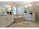 Primary bathroom with double sinks, soaking tub and separate shower at 6248 Champions Row, Bradenton, FL 34210