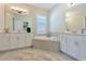 Bathroom boasts a large soaking tub and double vanities at 6248 Champions Row, Bradenton, FL 34210