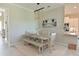 Light and airy dining room with a rustic table and bench at 6248 Champions Row, Bradenton, FL 34210
