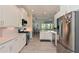 Bright kitchen boasts stainless steel appliances and white cabinets at 6248 Champions Row, Bradenton, FL 34210