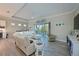 Spacious living room with a sectional sofa, large sliding doors, and hardwood floors at 6248 Champions Row, Bradenton, FL 34210