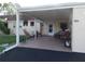 Covered patio with seating area, landscaping, and hanging flower baskets at 670 Park Cir, Bradenton, FL 34207