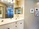 Double vanity bathroom with updated fixtures and a large mirror at 7225 Cedar Hollow Cir # 20-201, Bradenton, FL 34203