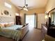 Bright and airy main bedroom featuring a king bed, walk-in closet, and balcony access at 7225 Cedar Hollow Cir # 20-201, Bradenton, FL 34203