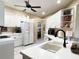 Bright kitchen with white cabinets, granite countertops, and stainless steel appliances at 7225 Cedar Hollow Cir # 20-201, Bradenton, FL 34203