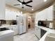 Spacious kitchen featuring white cabinetry, updated countertops, and modern appliances at 7225 Cedar Hollow Cir # 20-201, Bradenton, FL 34203