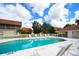Community pool with lounge chairs and surrounding patio at 7225 Cedar Hollow Cir # 20-201, Bradenton, FL 34203