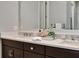 Double vanity bathroom with modern finishes and a large mirror at 7240 Whittlebury Trl, Bradenton, FL 34202