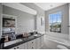 Elegant bathroom with double sinks, granite countertop, and a soaking tub at 7584 Andora Dr, Sarasota, FL 34238