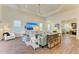 Open living area with hardwood floors, a large TV, and views into other rooms at 1049 River Wind Cir, Bradenton, FL 34212