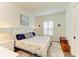 Cozy bedroom with a king-size bed, plantation shutters, and hardwood floors at 1049 River Wind Cir, Bradenton, FL 34212