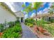 Brick walkway leading to the front entrance, surrounded by tropical landscaping at 1049 River Wind Cir, Bradenton, FL 34212