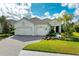 Beautiful home with a three-car garage and lush landscaping at 1049 River Wind Cir, Bradenton, FL 34212