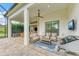 Covered patio with seating area, grill, and screened enclosure at 1049 River Wind Cir, Bradenton, FL 34212