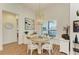 Charming dining area with round wooden table and white chairs at 1049 River Wind Cir, Bradenton, FL 34212
