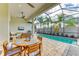 Outdoor kitchen and dining area overlooking the pool at 1049 River Wind Cir, Bradenton, FL 34212